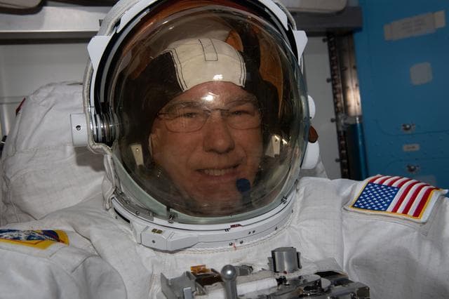 NASA image: Astronaut Stephen Bowen tries on his spacesuit ahead of a spacewalk