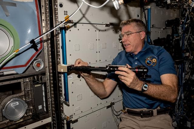 NASA image: Astronaut Stephen Bowen installs student-made hardware
