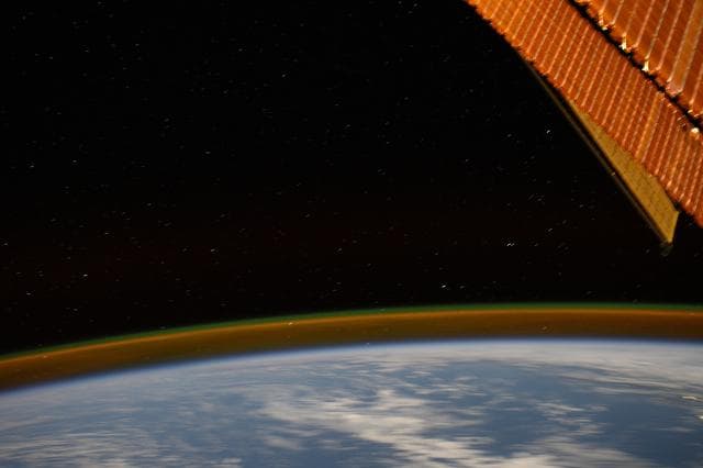 NASA image: A Golden Atmospheric Glow Crowns Earth's Horizon