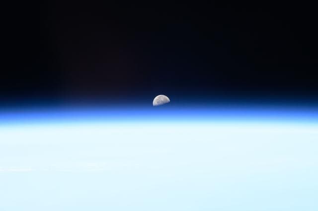 NASA image: The third quarter Moon rises above Earth