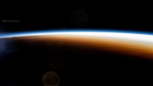 NASA image: An orbital sunrise colorfully illuminates the Earth's atmosphere