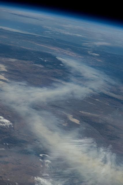 NASA image: A wildfire in Canada and its smoke spreading in the atmosphere