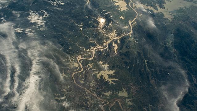 NASA image: The Yangtze River beams in the Sun's glint and surrounded by wildfires