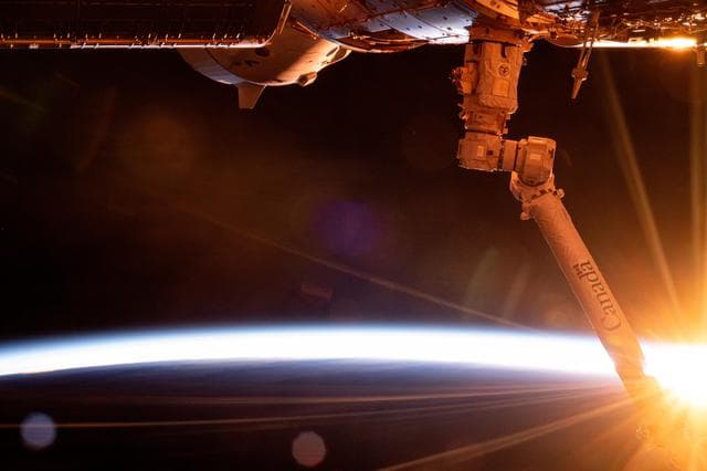 NASA image: The first rays of an orbital sunrise breakthrough illuminating Earth's atmosphere