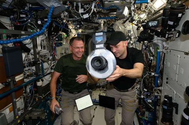 NASA image: Astronauts Nick Hague and Matthew Dominick check out camera gear