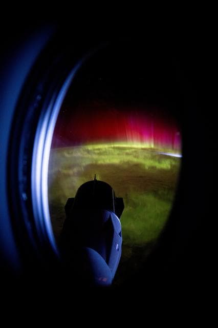 NASA image: The SpaceX Dragon Freedom spacecraft is pictured as auroras move through Earth's atmosphere