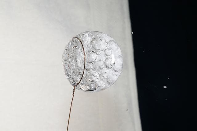 NASA image: A sphere of water fizzes with an antacid pill inside