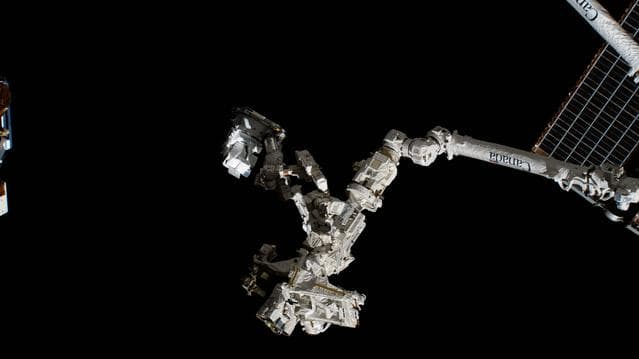 NASA image: The fine-tuned robotic hand, better known as Dextre, carries the CODEX experiment