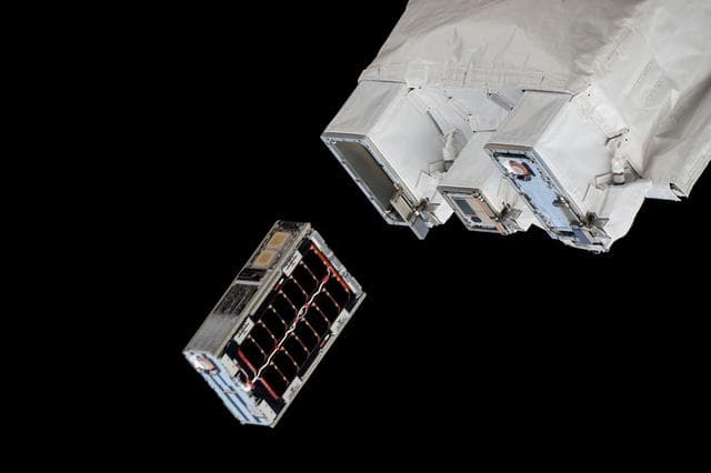 NASA image: A CubeSat is ejected into Earth orbit from a small satellite orbital deployer
