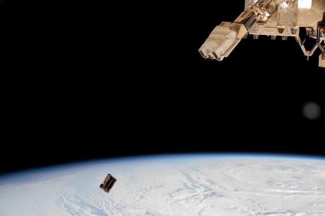 NASA image: A CubeSat is ejected into Earth orbit from a small satellite orbital deployer