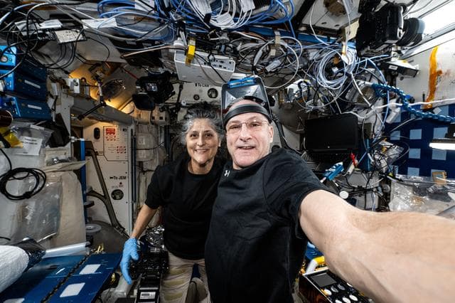 NASA image: Astronauts Suni Williams and Don Pettit pose for a selfie-portrait