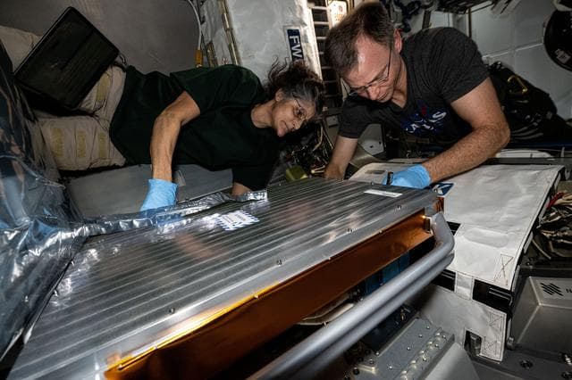 NASA image: Astronauts Suni Williams and Nick Hague install the European Materials Ageing experiment