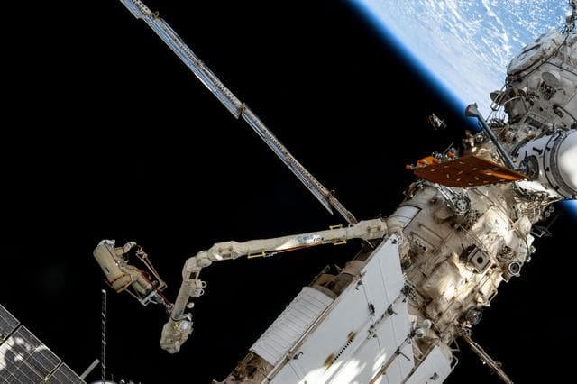 NASA image: Roscosmos cosmonaut Alexey Ovchinin rides the European robotic arm