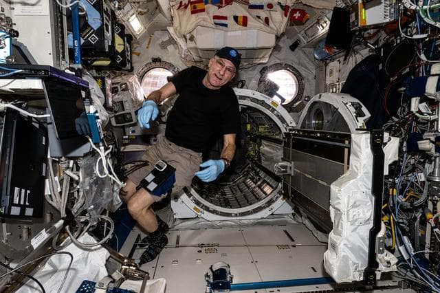 NASA image: Astronaut Don Pettit removes the small satellite orbital deployer