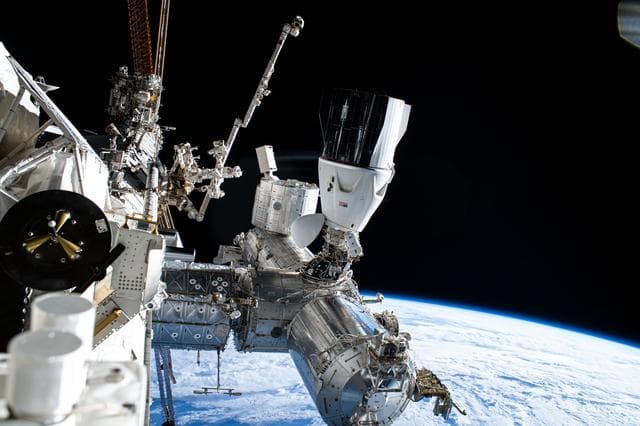 NASA image: Astronaut Suni Williams is dwarfed near the SpaceX Dragon crew spacecraft