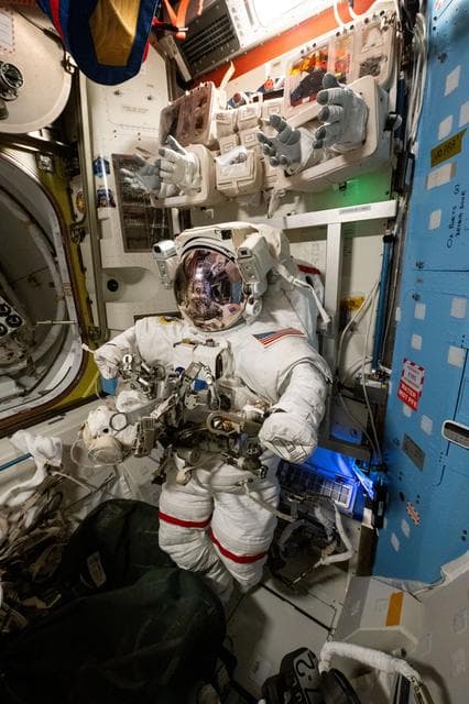 NASA image: A spacesuit is pictured staged inside the Quest airlock