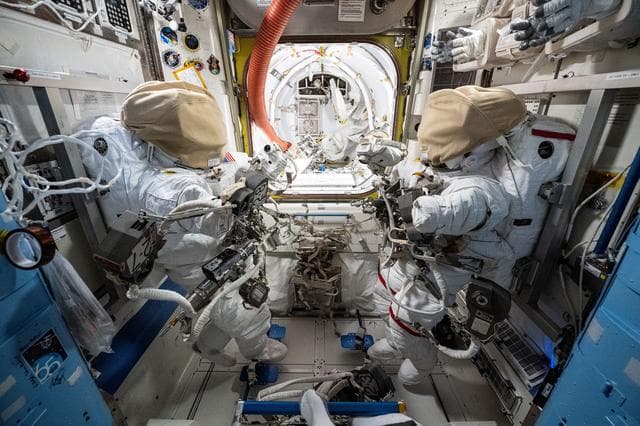 NASA image: Two spacesuits are staged inside the International Space Station's Quest airlock