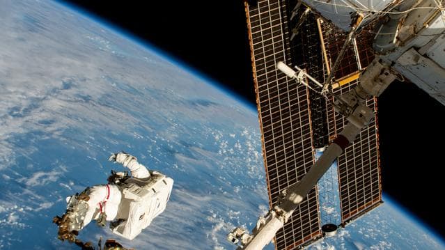 NASA image: Astronaut is attached to the Canadarm2 robotic arm's latching end effector