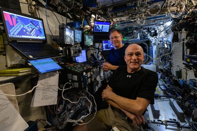 NASA image: NASA astronauts Don Pettit and Nick Hague at the controls of the robotics workstation