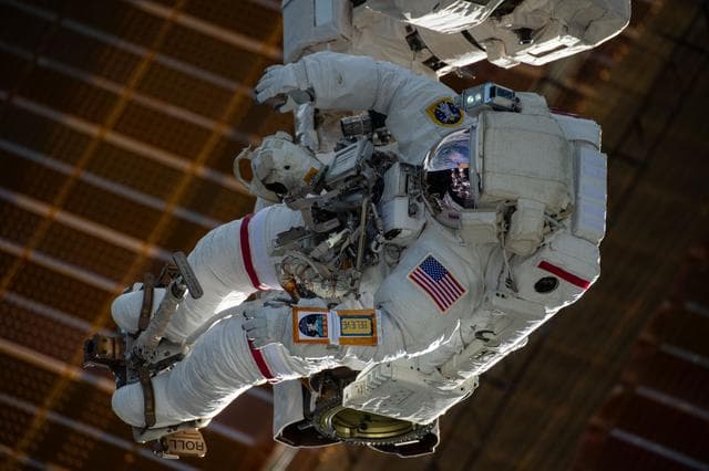 NASA image: Astronaut is attached to the Canadarm2 robotic arm's latching end effector