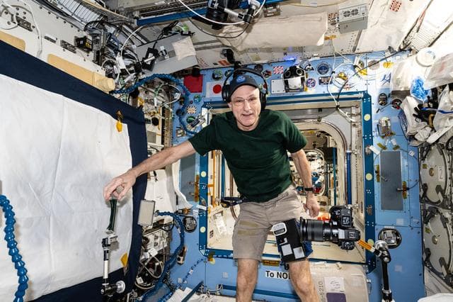 NASA image: Astronaut Don Pettit sets up camera hardware to photograph research activities