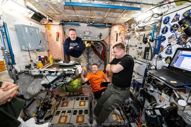 NASA image: Expedition 72 crew members join each other for dessert