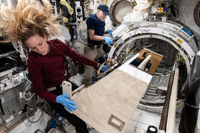 NASA image: NASA astronauts Don Pettit and Nichole Ayers work on the NanoRacks External Platform