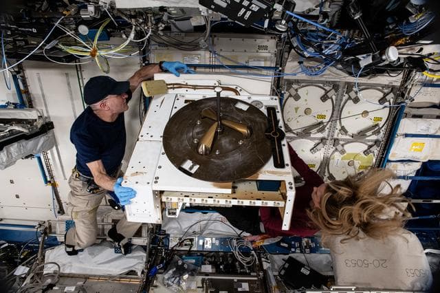 NASA image: NASA astronauts Don Pettit and Nichole Ayers work on the NanoRacks External Platform
