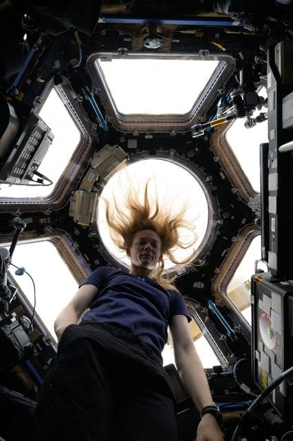 NASA image: Astronaut Nichole Ayers poses for a portrait inside the seven window cupola