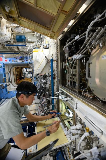 NASA image: Astronaut Takuya Onishi inspects science hardware inside the Kibo laboratory module