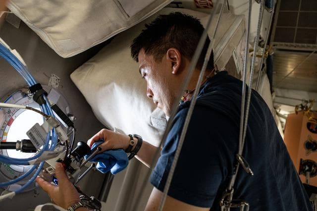 NASA image: Astronaut Jonny Kim works on orbital plumbing duties
