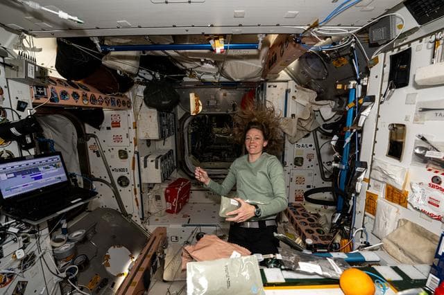 NASA image: Astronaut prepares for a midday meal aboard the Unity module