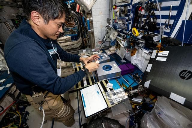 NASA image: Astronaut Takuya Onishi processes cassettes containing biological fluid samples