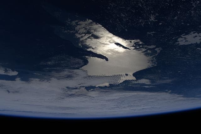 NASA image: Oblique of view of the sun's glint beaming off Lake Superior