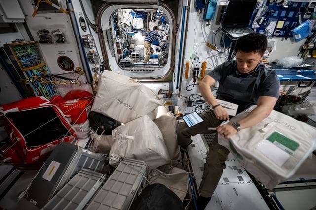 NASA image: Astronaut Jonny Kim gathers cargo to be packed inside the SpaceX Dragon cargo spacecraft