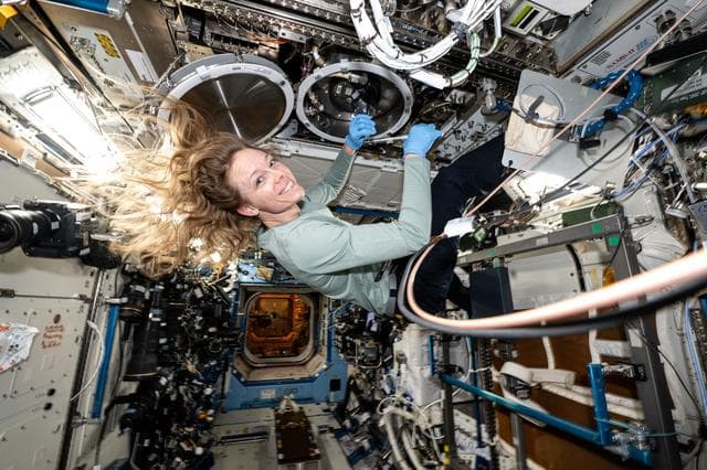 NASA image: NASA astronaut Nichole Ayers swaps sample cartridges inside the Material Science Laboratory