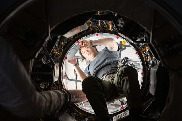 NASA image: Astronaut Jonny Kim works inside the SpaceX Dragon cargo spacecraft completing cargo operations