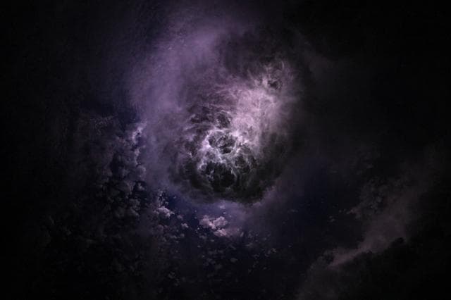 NASA image: Lightning illuminates the clouds during a storm off the coast of North Carolina