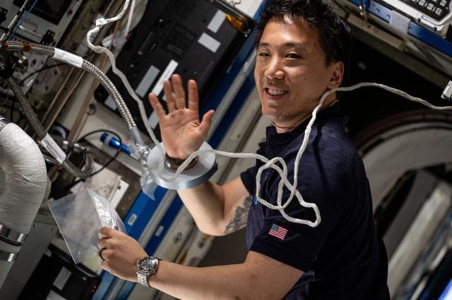 NASA image: Astronaut Jonny Kim services an experimental carbon dioxide removal device