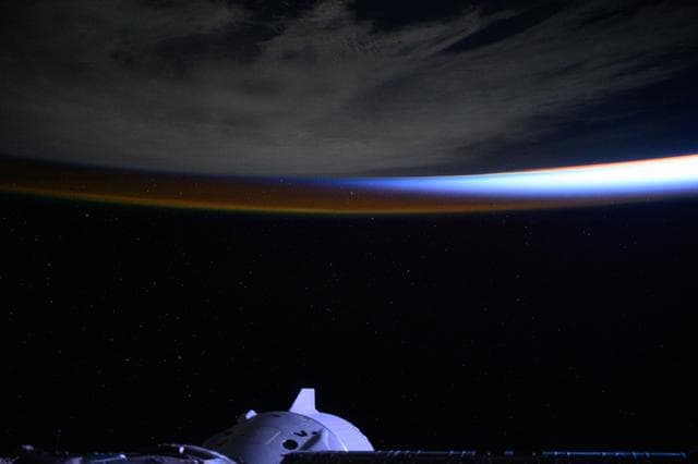NASA image: An orbital sunrise breaks above a cloudy Atlantic Ocean