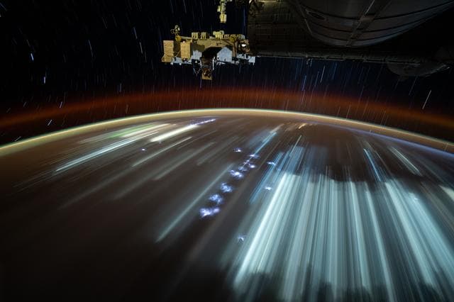 NASA image: Indonesian city lights and lightning storms streak below