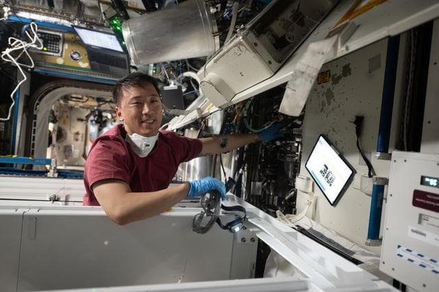 NASA image: NASA astronaut Jonny Kim works on orbital plumbing tasks