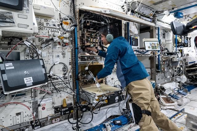 NASA image: JAXA astronaut Takuya Onishi troubleshoots and inspects combustion research hardware