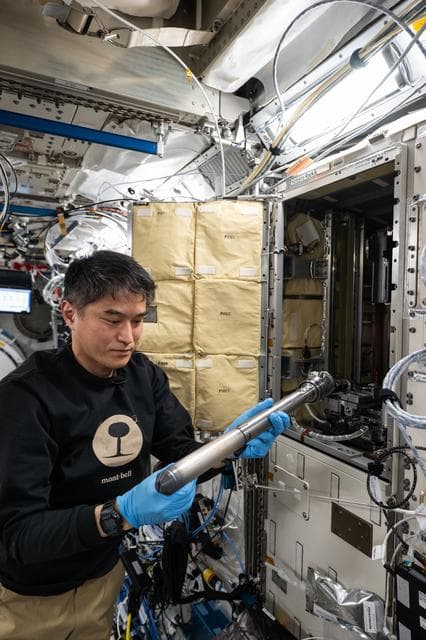NASA image: JAXA astronaut Takuya Onishi removes experiment hardware and sample cartridges 