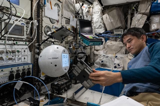 NASA image: JAXA astronaut Takuya Onishi sets up the CIMON AI-powered robotic assistant