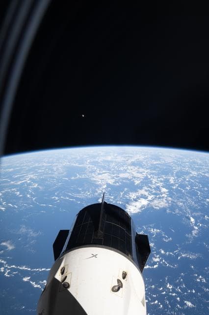 NASA image: The SpaceX Dragon crew spacecraft and the Waxing Gibbous Moon