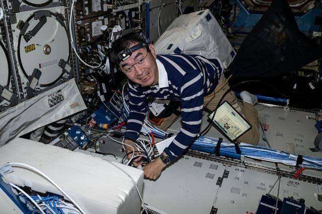 NASA image: JAXA Astronaut Kimiya Yui unpacks science, supplies, and hardware