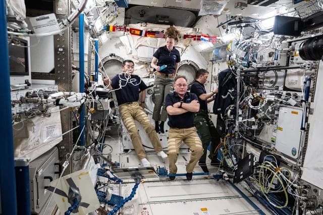 Expedition 73 Flight Engineers gather together inside the Kibo laboratory module