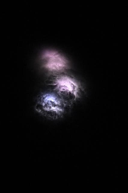 NASA image: Lightning strikes illuminate the stormy cloud tops