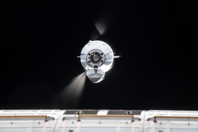 The SpaceX Dragon cargo spacecraft fires its Draco engines